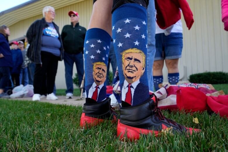 People wait to enter a campaign event for former U.S. president Donald Trump in Waunakee, Wis., on Tuesday, Oct. 1, 2024.