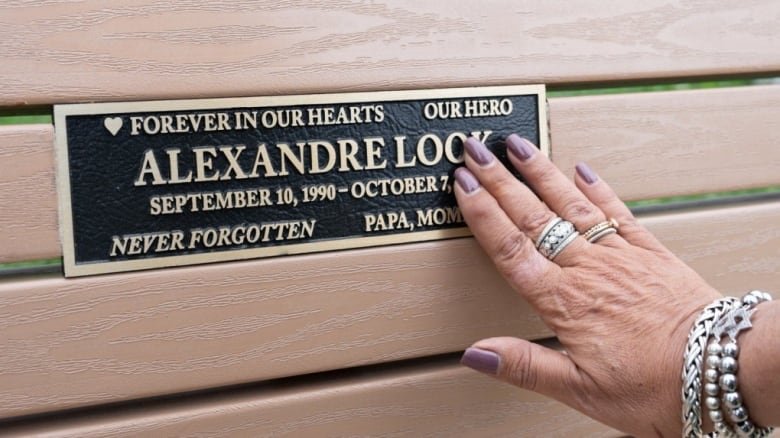 hand touching plaque.