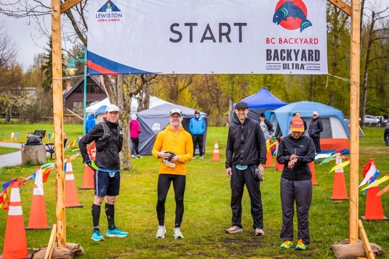 Four people line up at the starting line for another loop at the BC Backyard Ultra