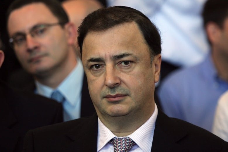 A close up shot of a man wearing a suit in a courthouse.