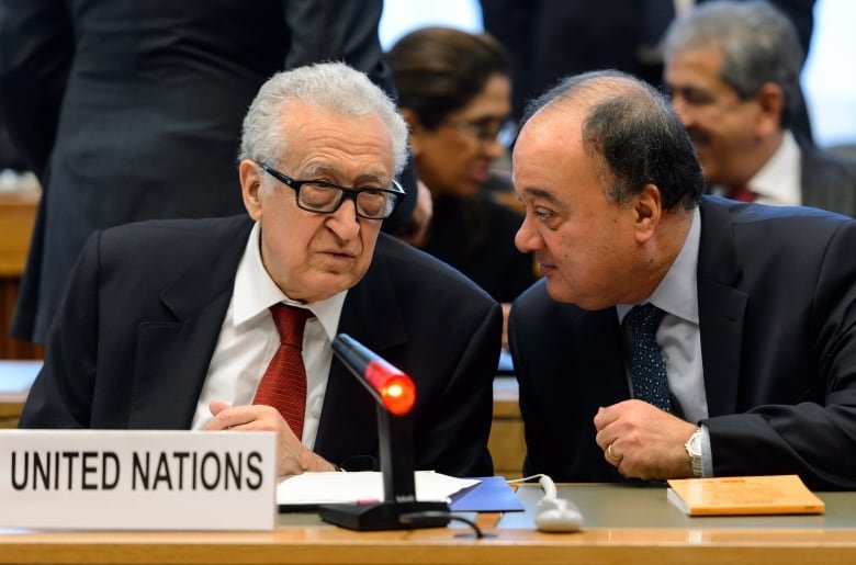 UN-Arab League envoy Lakhdar Brahimi, left, speaks with UN-Arab League deputy envoy Nasser Al-Kidwa prior to a meeting at the United Nations office in Geneva, Switzerland on Friday, Dec. 20, 2013.