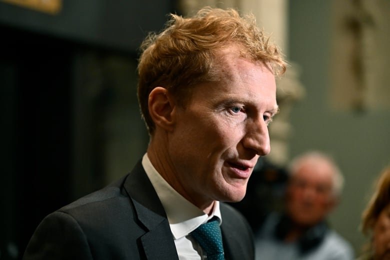 Minister of Immigration, Refugees and Citizenship Marc Miller takes questions from reporters as the Liberal caucus meets on Parliament Hill in Ottawa on Wednesday, Oct. 9, 2024.