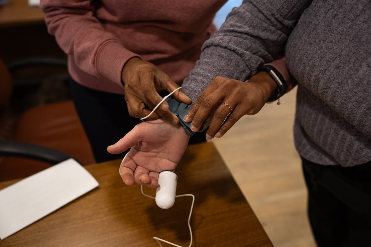 The photo shows someone's finger linked to a machine that seems to be monitoring something.