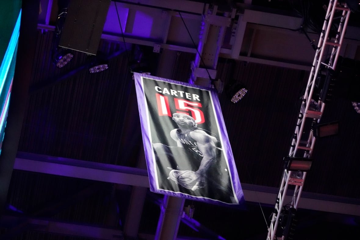 A banner depicting a basketball player hangs in the rafters.