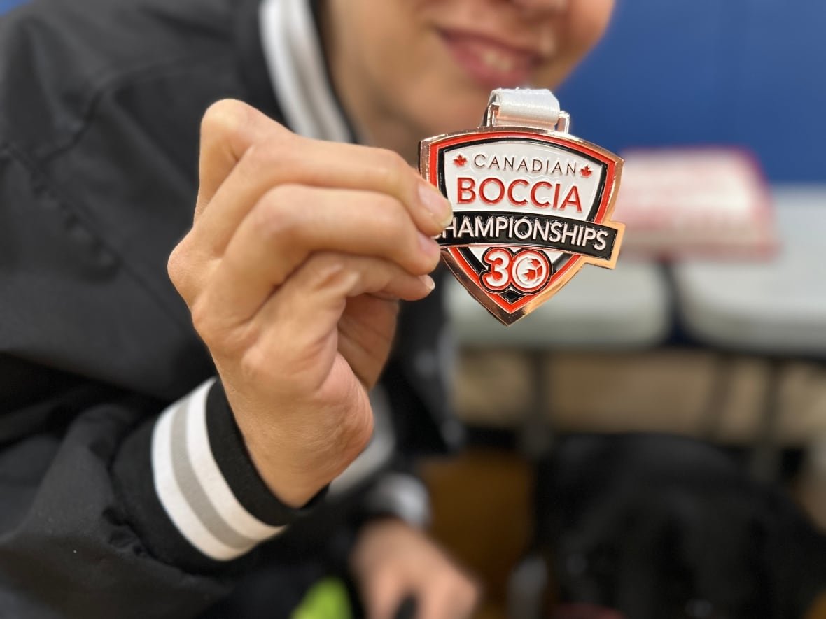 Liza Puri proudly holds the bronze medal she earned at the 2024 Canadian Boccia Championships where she was part of Team Ontario.