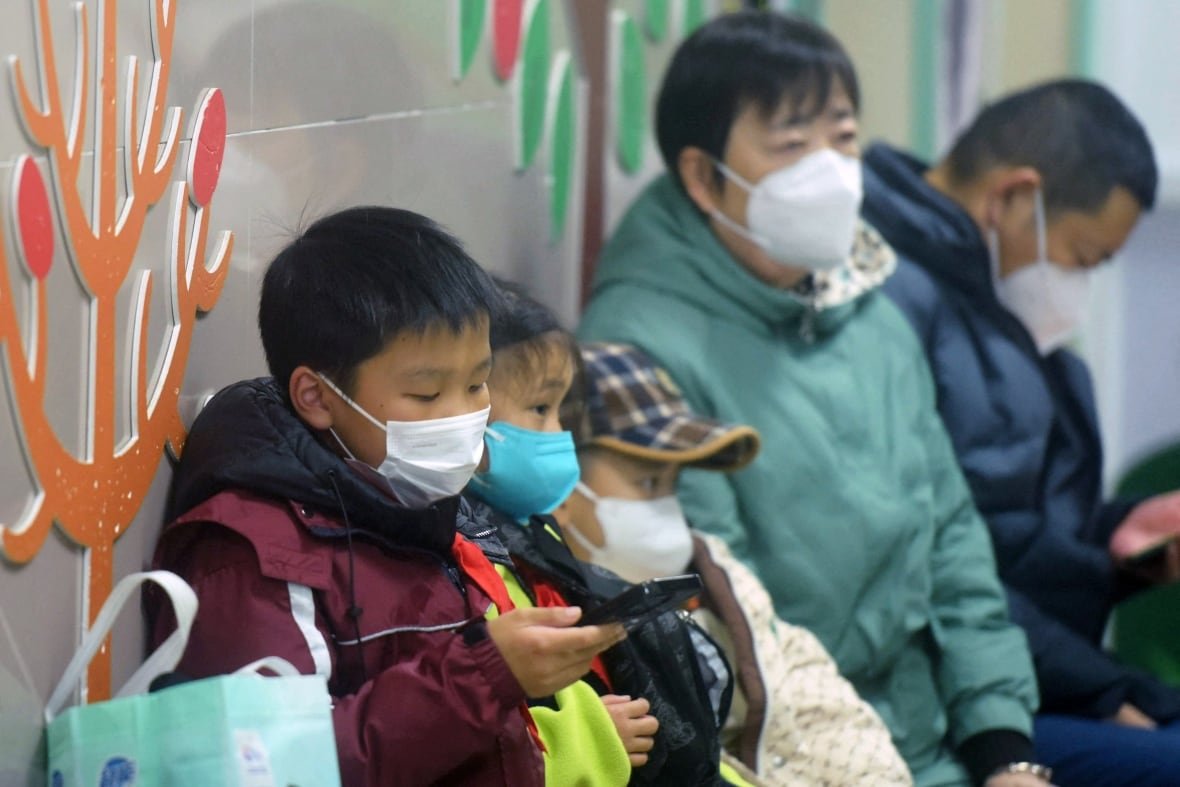 Masked children in China waiting to be seen by medical staff at a hospital.