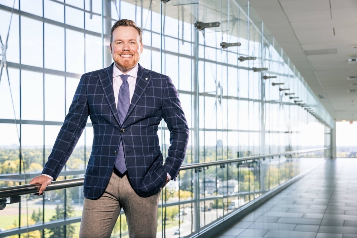 Dr. Adam Kinnaird smiles at the camera.