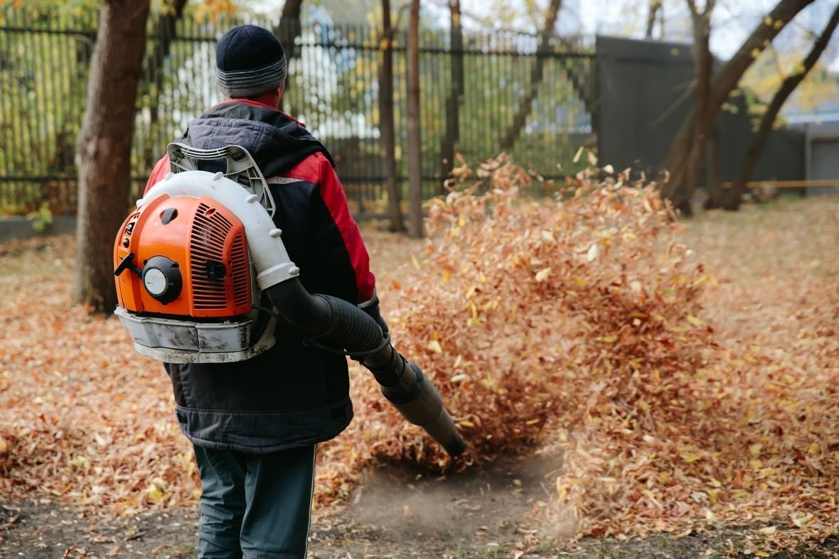 A man operates a leaf blower.