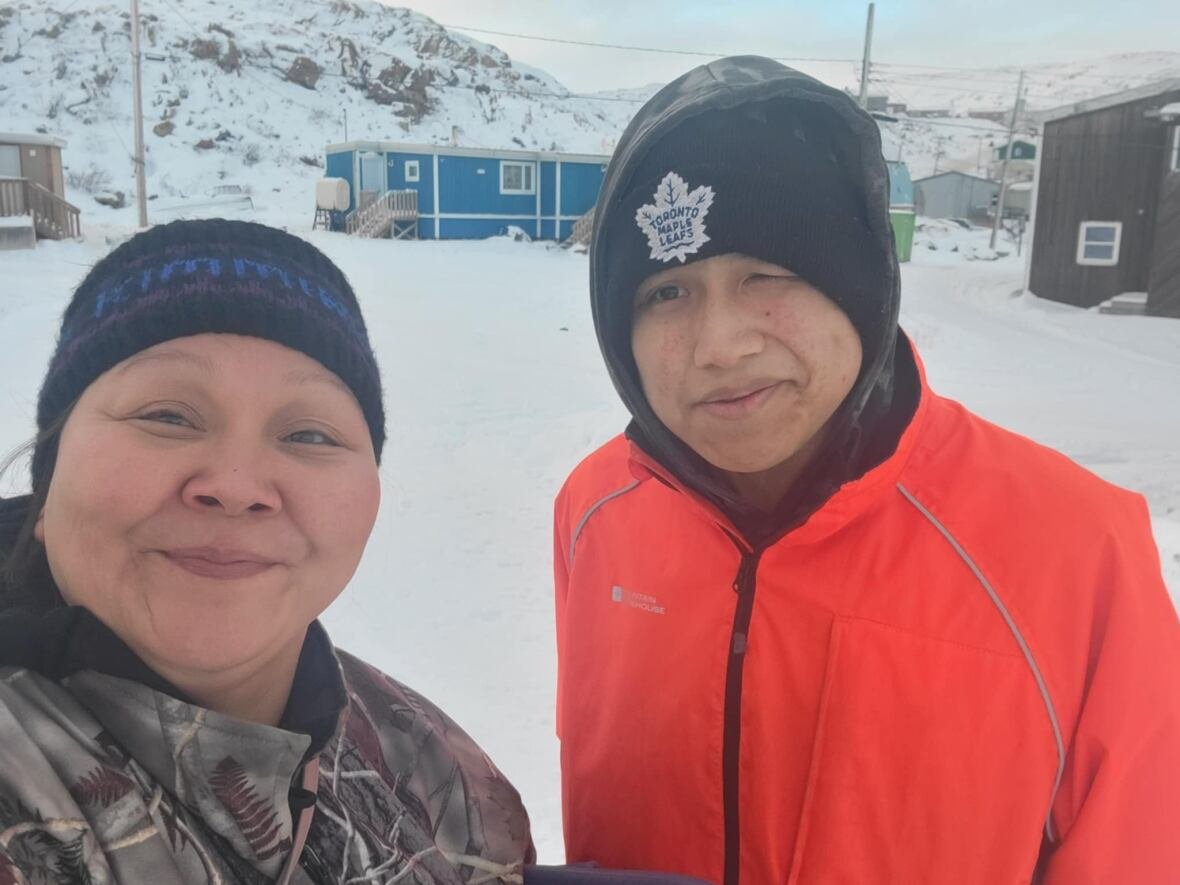 Woman and man standing in the snow