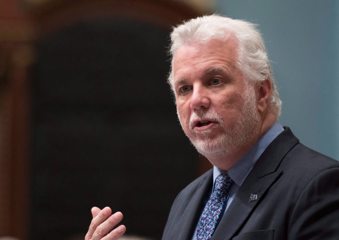 A man with white white and a beard speaking