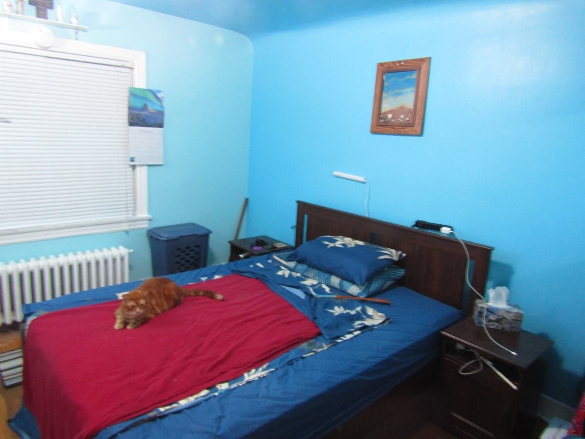 A bedroom with blue walls.